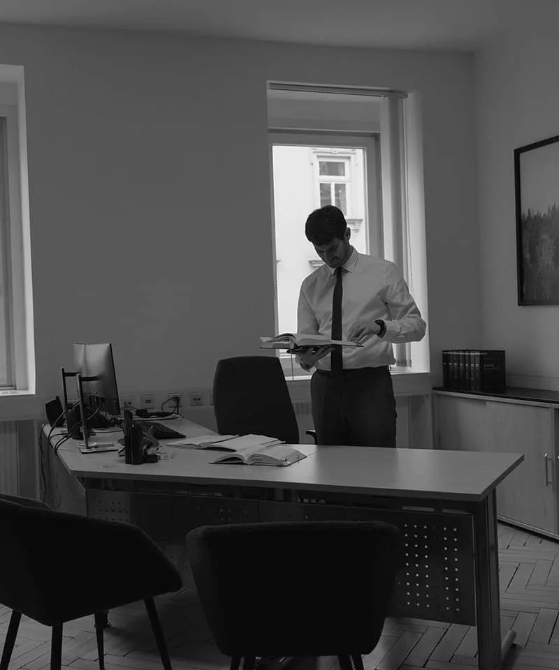 Rechtsanwalt mit einer Akte im Büro der Kanzlei in Innsbruck, Schwarz-Weiß-Aufnahme
